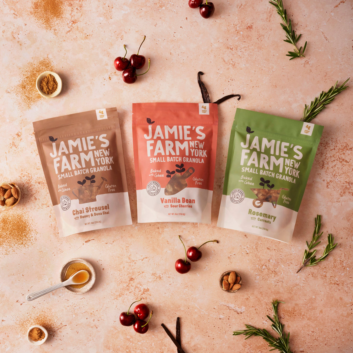 Three Jamie's Farm New York small-batch granola pouches with toppings around them