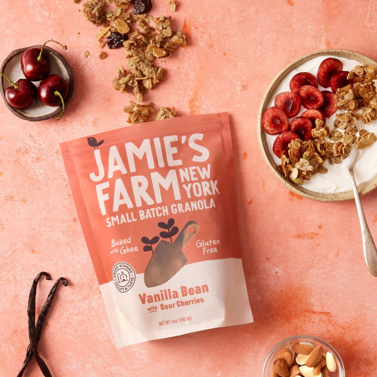 Vanilla bean granola pouch with cherries on top, plus a bowl of granola
