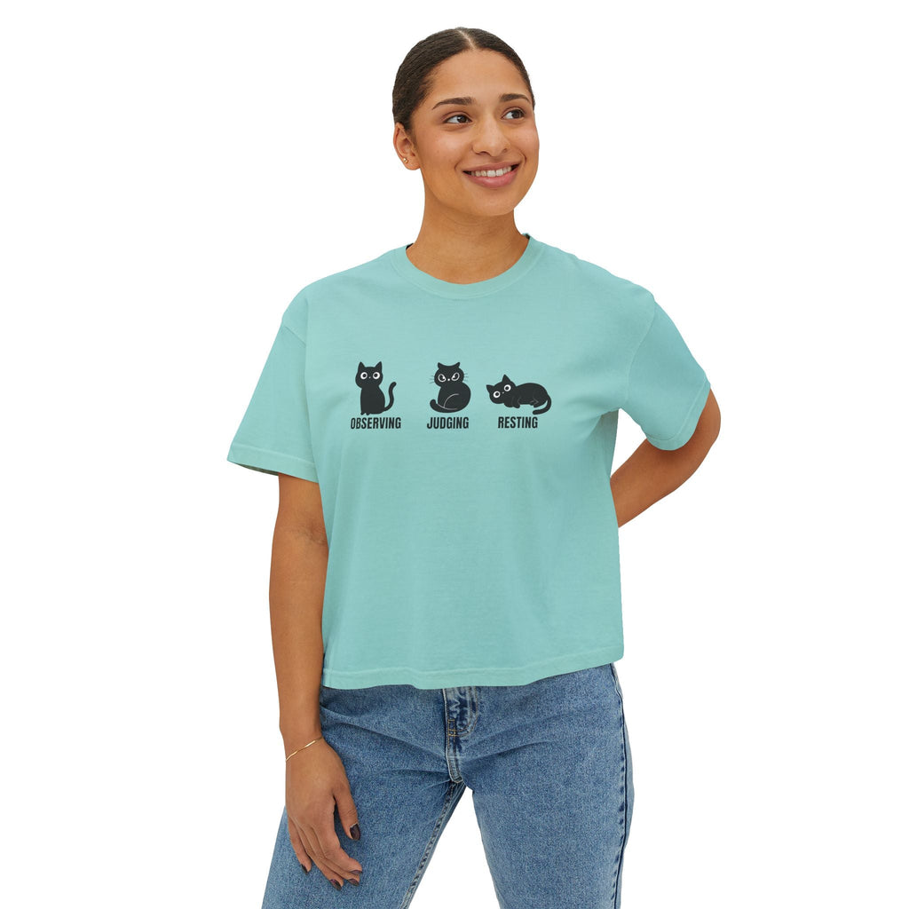 Mint blue boxy cat tee with three cat faces graphic: observing, judging, resting