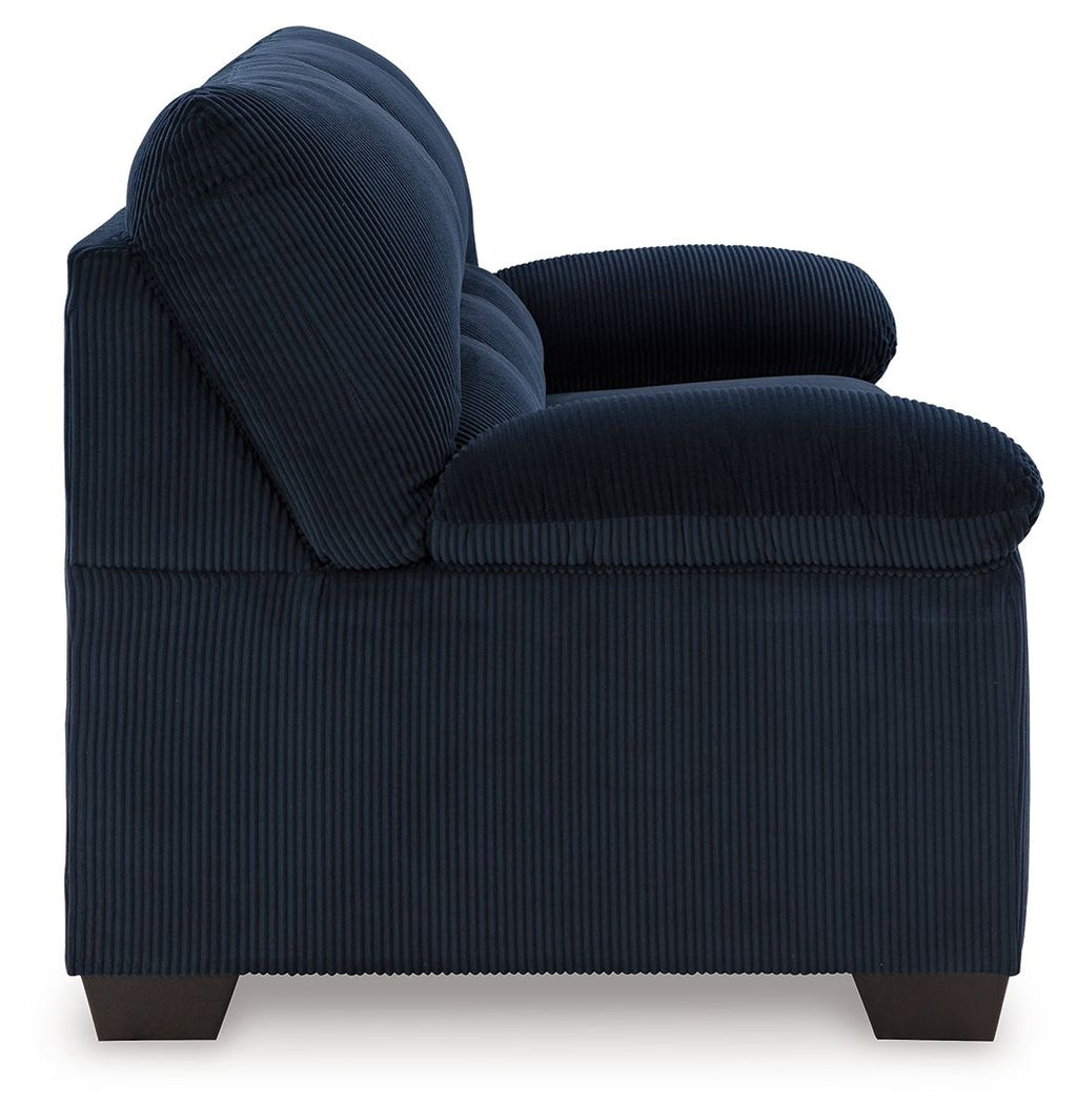 Blue sofa arm and seat with tufted back, vertical ribbed fabric texture