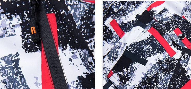 Ski suit fabric close-up with abstract pattern and red zipper trim.