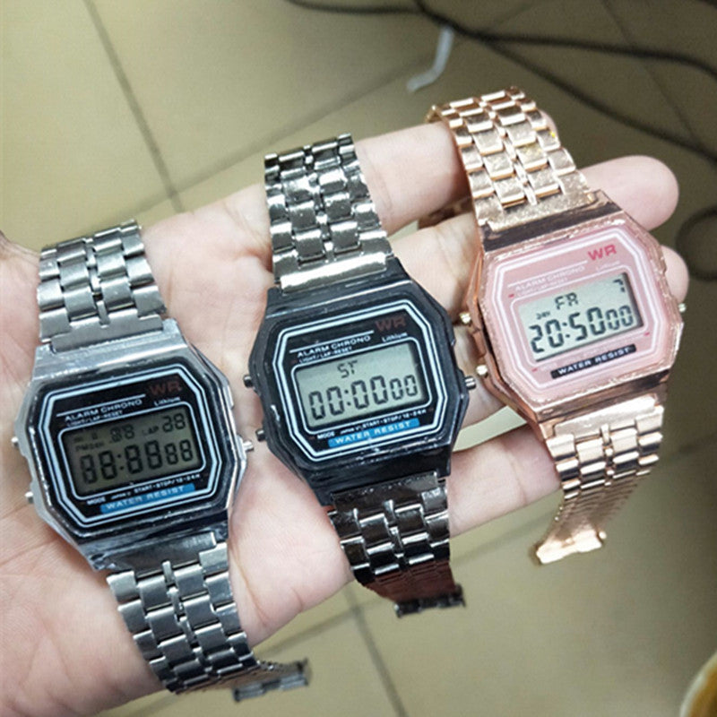 Assorted digital alarm chronograph watches in silver, black, and rose tones on hand