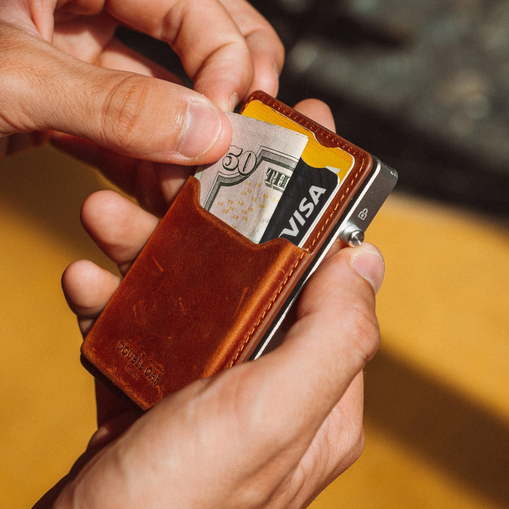 Brown leather mod wallet with exposed card, yellow trim, and metal hardware