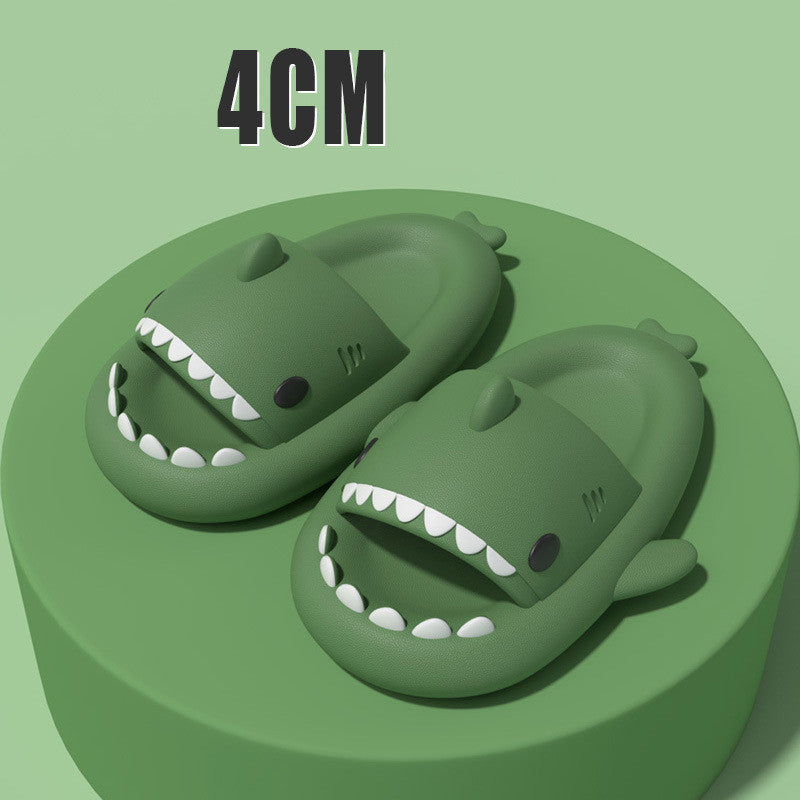 Green shark-shaped slide sandals with open toe and ridged white teeth details