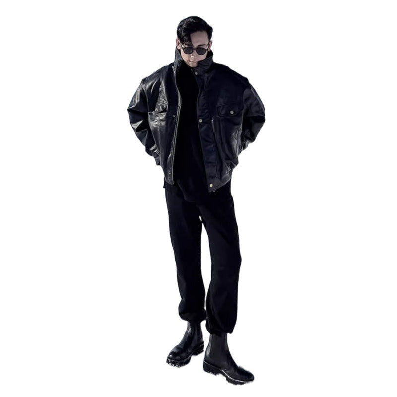 Men's black leather jacket with stand collar, snap front, and chest flap pockets, long sleeves