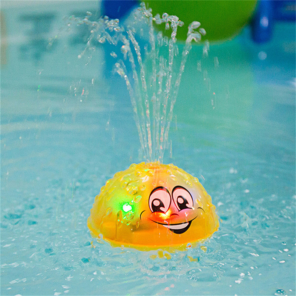 Yellow smiling UFO water sprinkler toy splashing in a pool, kid swim play