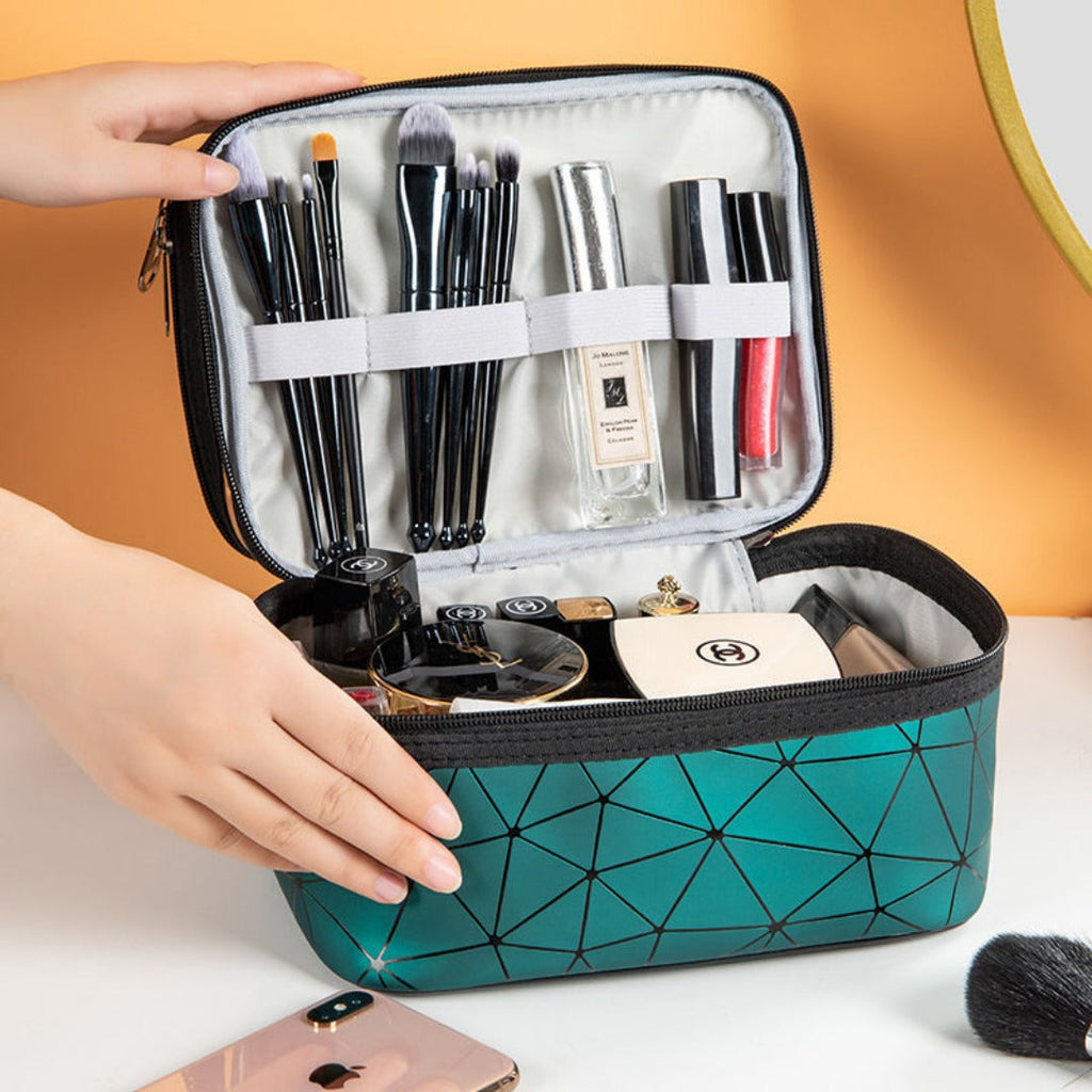 Open double cosmetic bag with clear top, teal geometric pattern and brush organizer inside