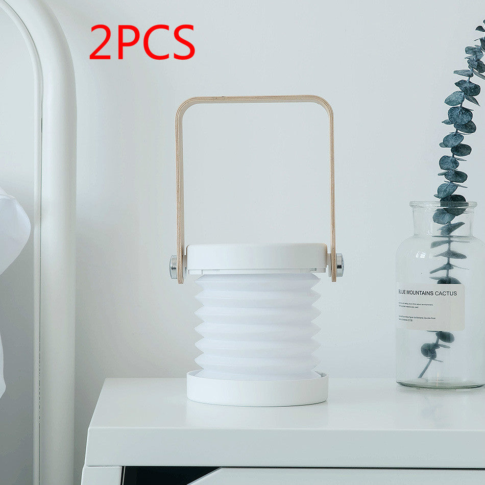 Foldable LED night light lantern with tan handle and ribbed white body, blue base ring