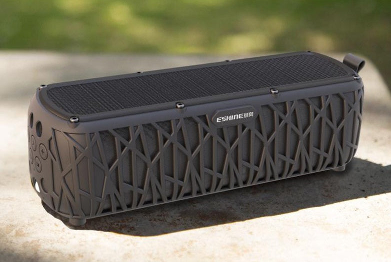 Blue solar Bluetooth speaker, compact barrel shape, side grille and top controls