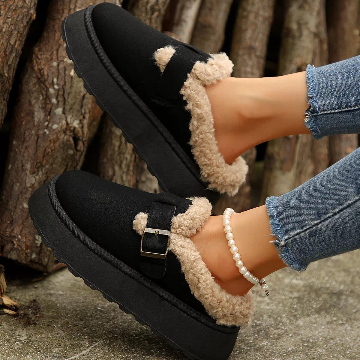 Black slip-on platform slippers with fuzzy lining and buckle strap