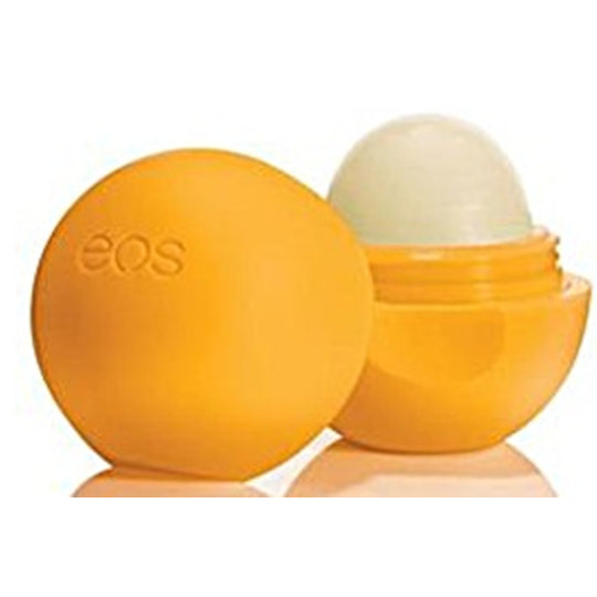 EOS tangerine lip balm in orange spherical container with open balm