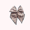 Boho print fabric bow with dark trim, tied in a large overhand knot