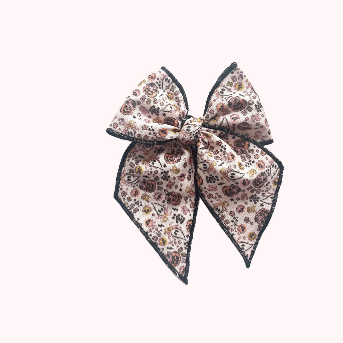 Boho print fabric bow with dark trim, tied in a large overhand knot
