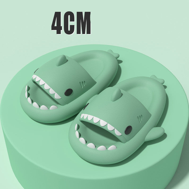 Green shark-shaped slide sandals with open toe and dorsal fin