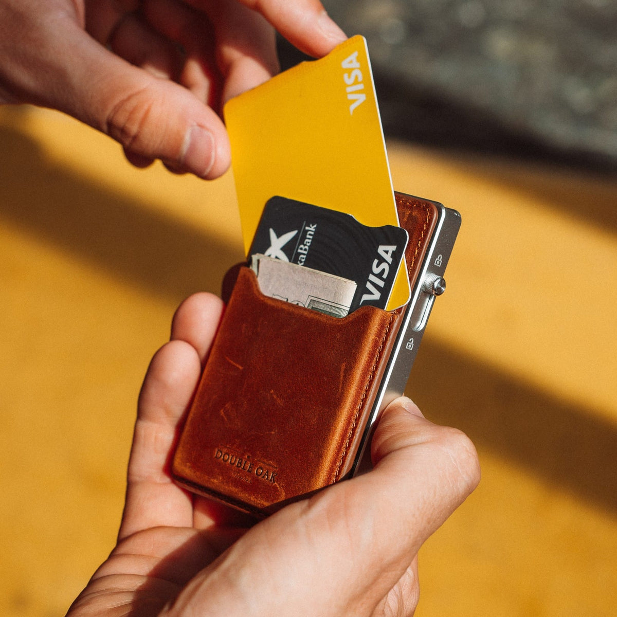 Brown leather card mod wallet with cards and gold-tone frame