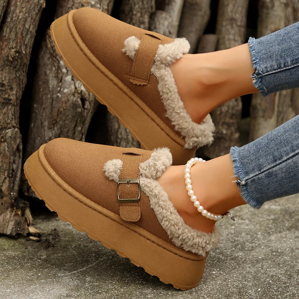 Brown platform slippers with fuzzy lining and buckle strap on thick sole