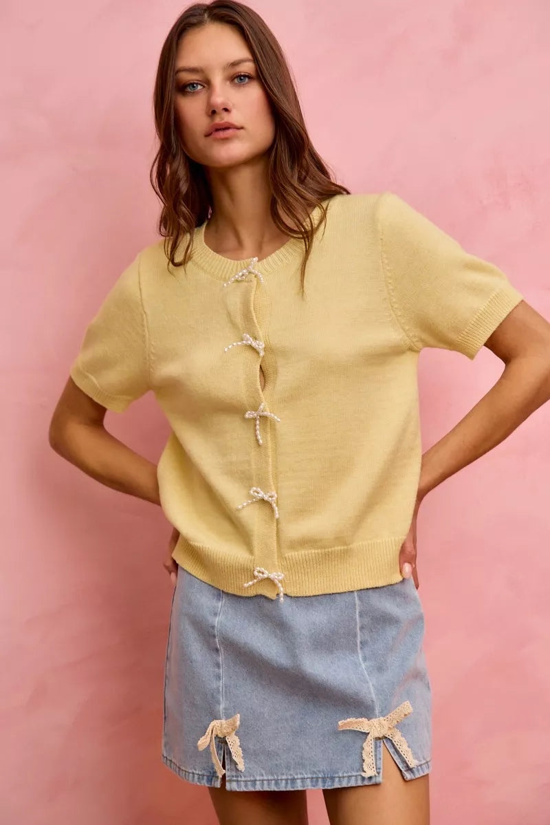 Denim mini skirt with lace ribbon bow accents at hem, light-wash
