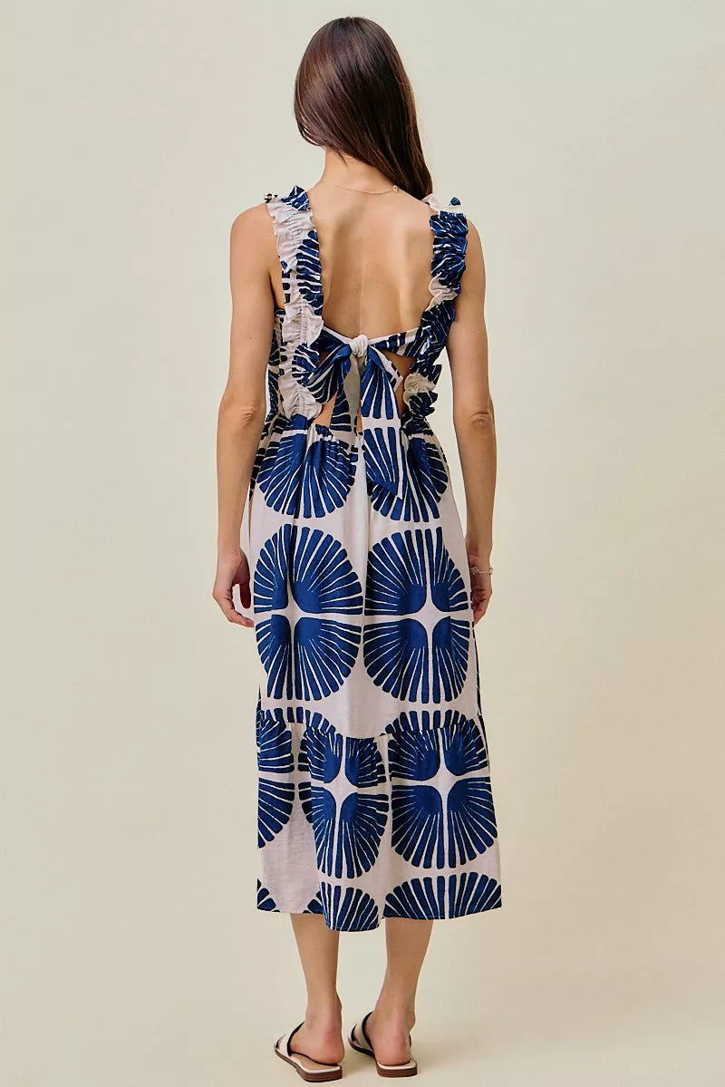 Back view of navy and white abstract print midi dress with smocked bodice