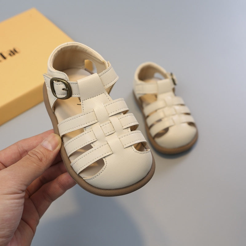 Beige toddler closed-toe woven sandals close-up, hook-and-loop ankle strap