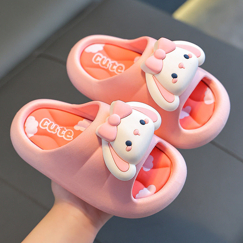 Kids bunny slide slippers in pink with bow and orange inner, shown side-by-side