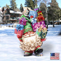 Holiday gnome yard decor holding colorful gift boxes, green hat, white beard