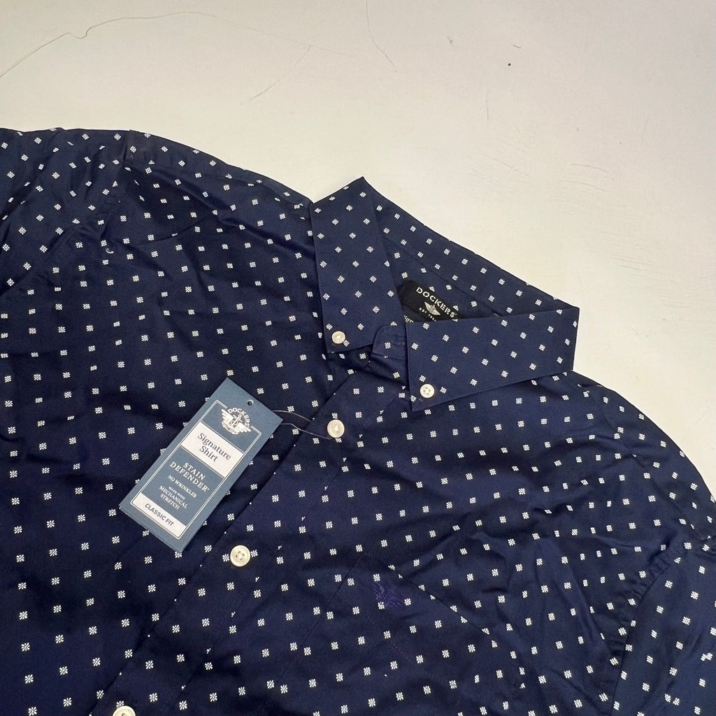 Navy men's button-up shirt collar with white daisy pattern and front button placket.