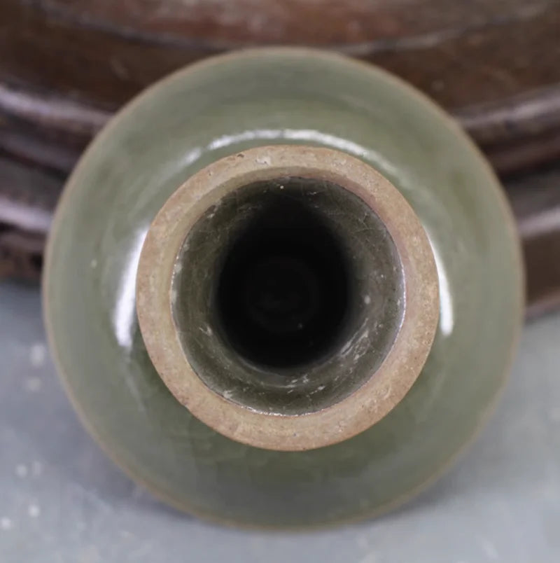 Bottom view of celadon pedestal porcelain bowl with unglazed ring and opening