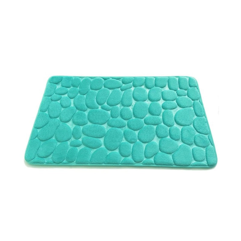 Teal cobblestone embossed memory foam bath mat with non-slip backing