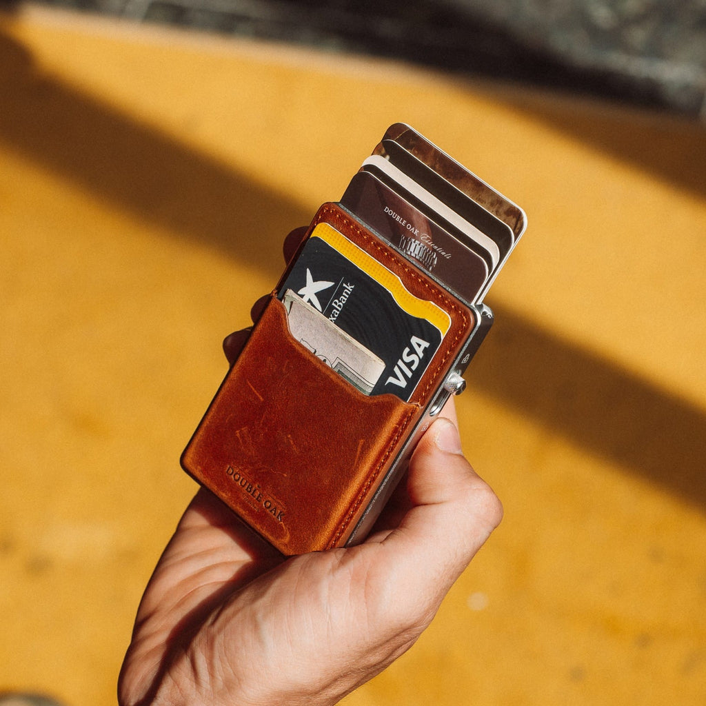 Brown leather mod wallet with card window and stacked card slots, held up