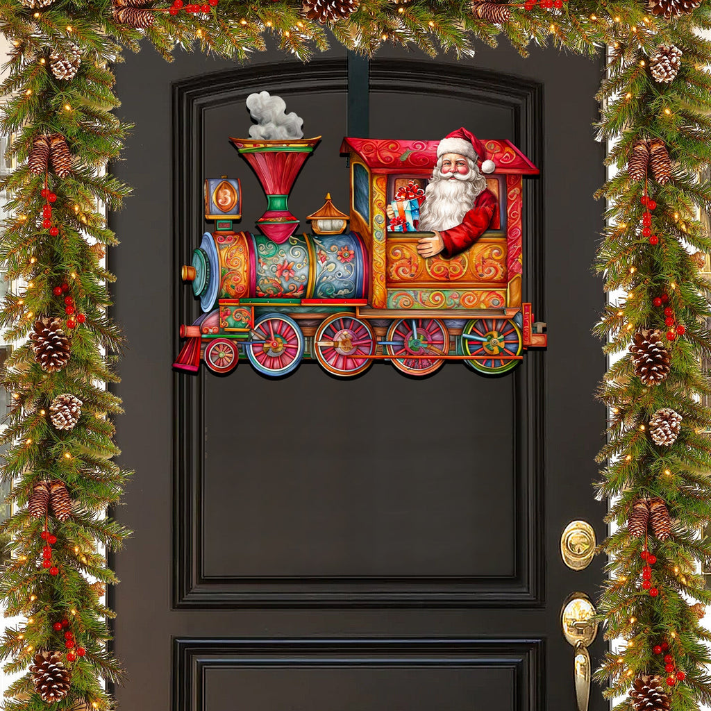Santa train door decoration centered on a dark door with snowman smokestack