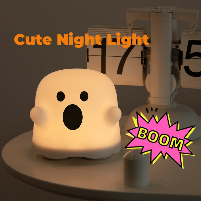 Silicone ghost night light lamp with smiling face, warm glowing bulb shape.