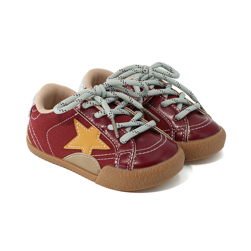 Girls sneakers in burgundy with gray laces, star patch, and tan rubber sole