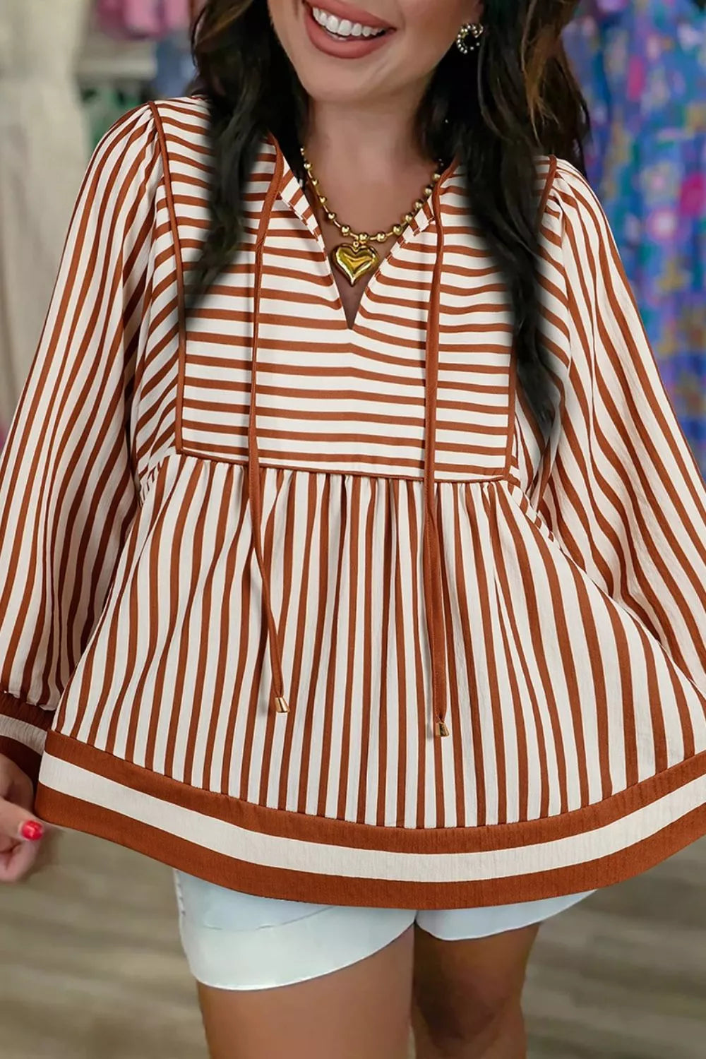 Striped babydoll long-sleeve blouse with V-neck and brown-and-white hem trim