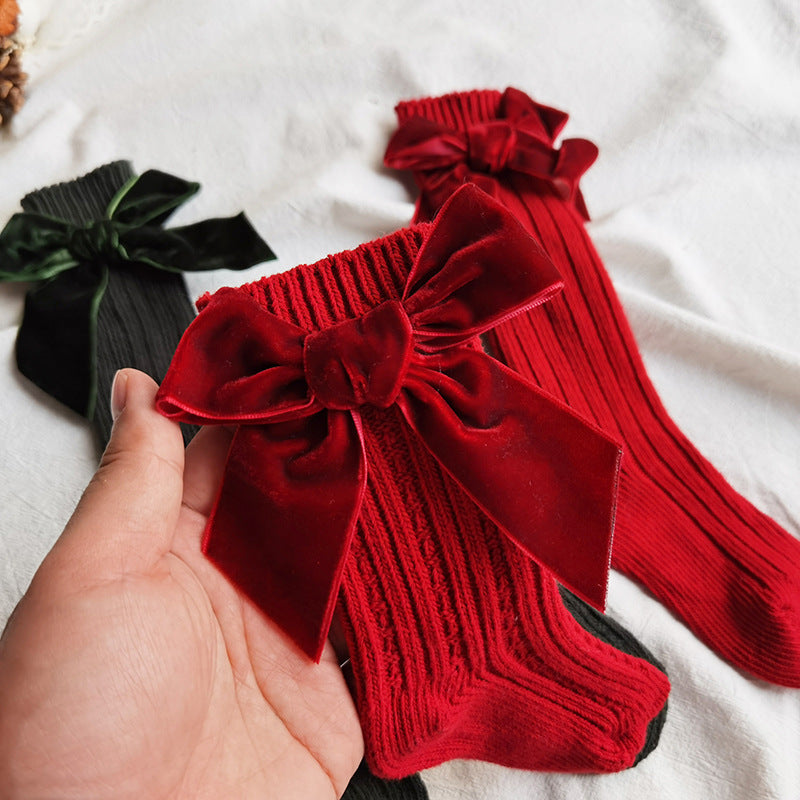 Red wool tube socks with bowknot cuffs and knitted texture