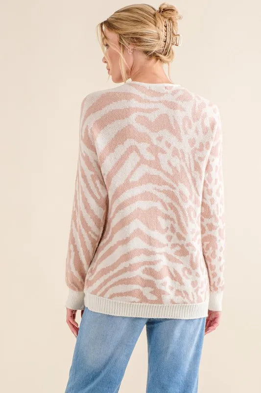 Pale pink knit sweater top with mixed animal print, round neck, long sleeves