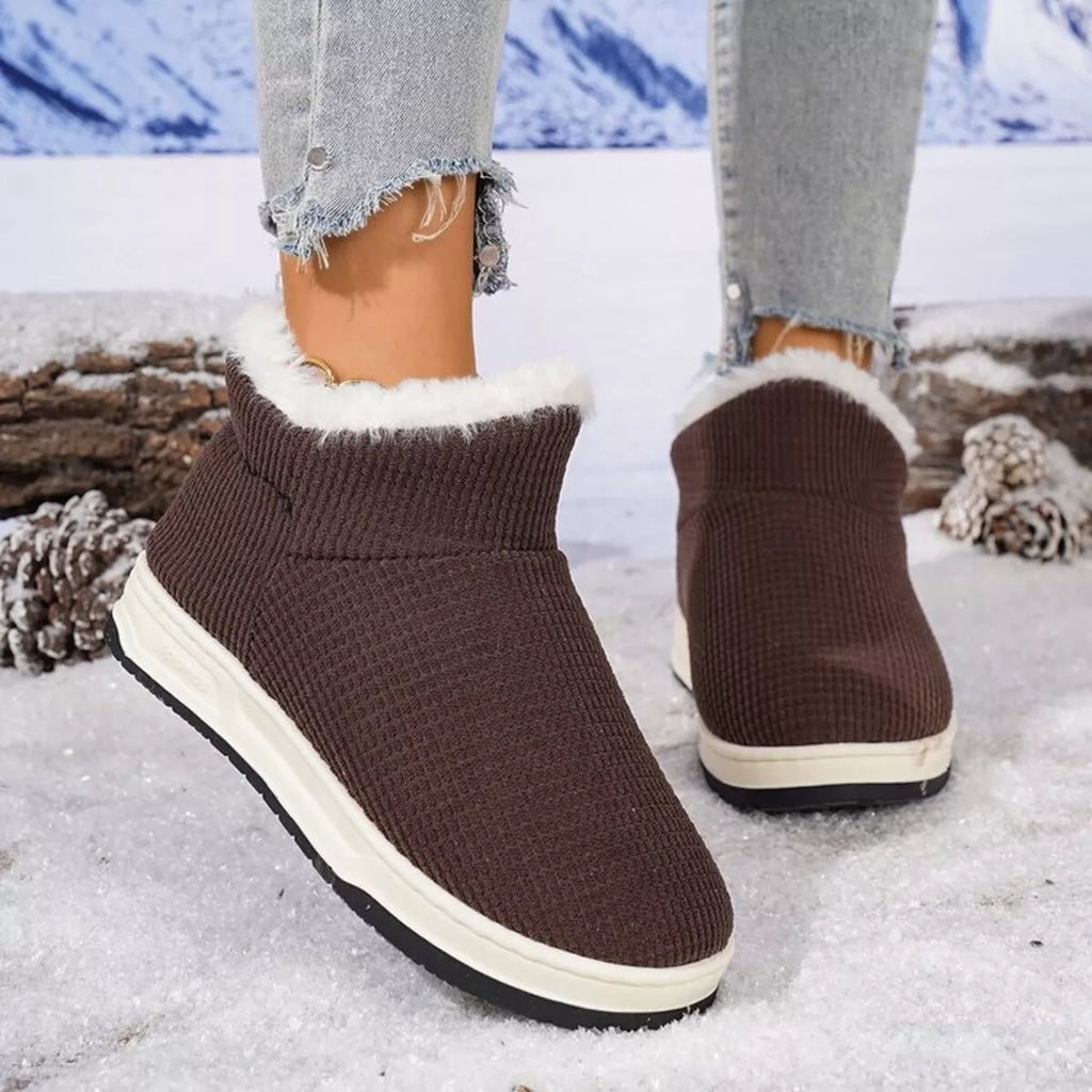 Chocolate brown knit ankle boots with plush white trim and side seam detail