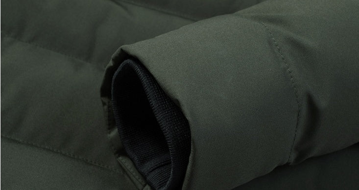 Padded sleeve cuff detail on dark green heated cotton coat