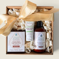 Ribbon-tied gift box with hand cream, body lotion, and sugar body scrub
