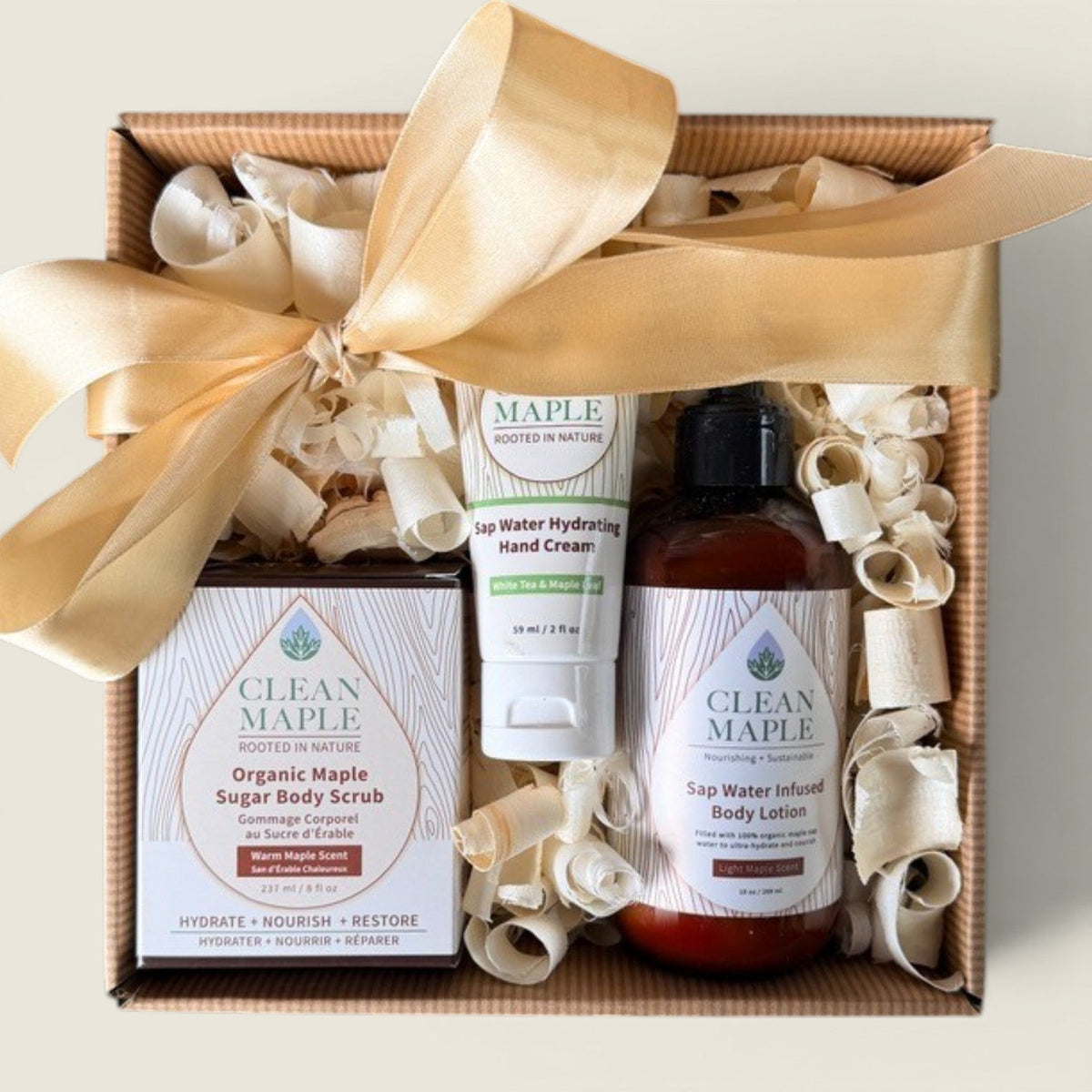 Ribbon-tied gift box with hand cream, body lotion, and sugar body scrub