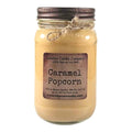Caramel popcorn candle in clear glass jar with dark metal lid and jute tie