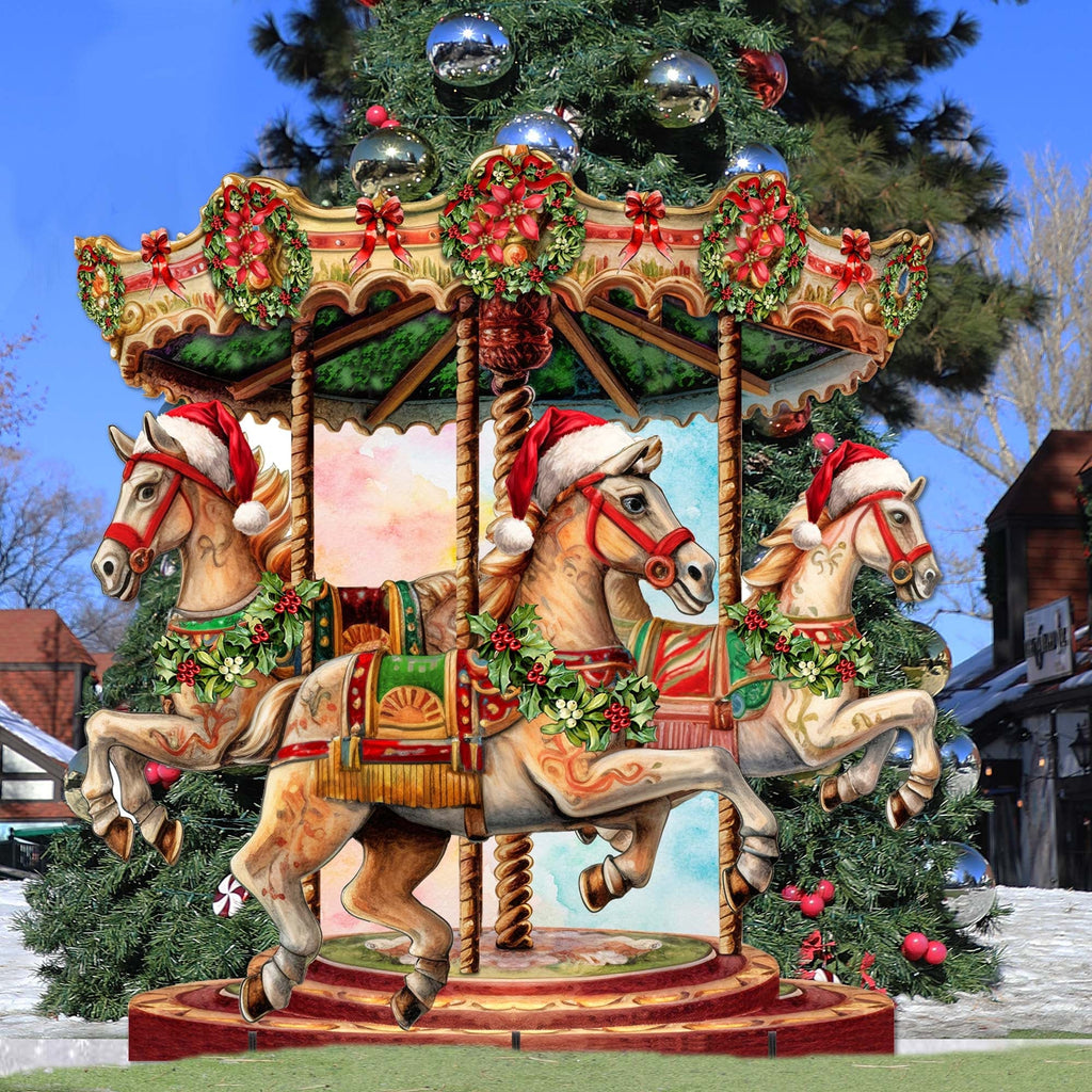 Christmas carousel outdoor decor with three horses on a rotating-style platform and holiday greenery