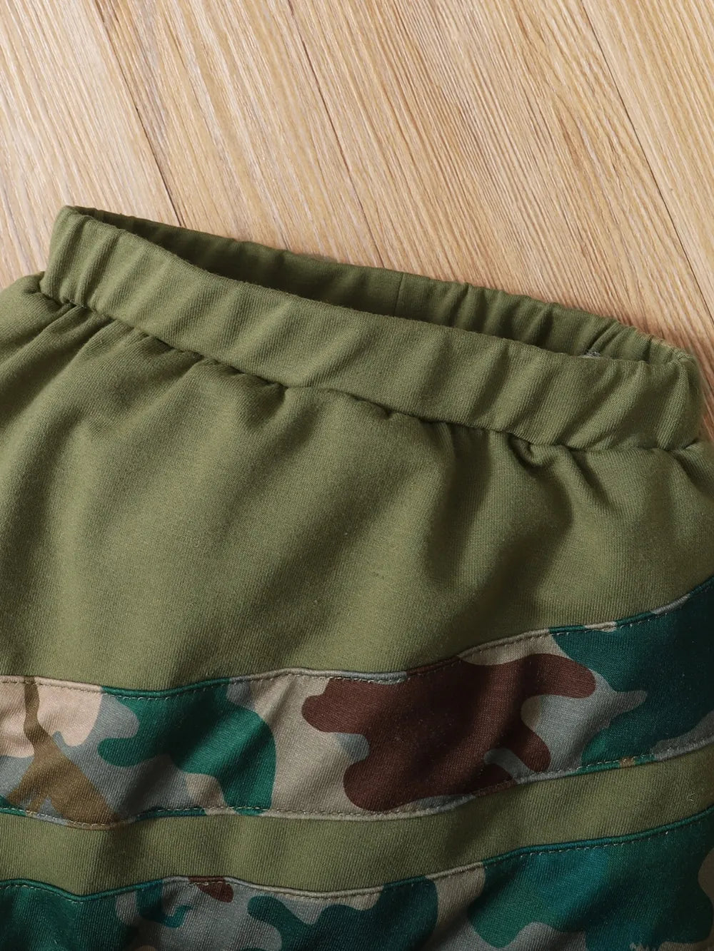 Kids’ camouflage pants with elastic waistband and layered camo hem panel