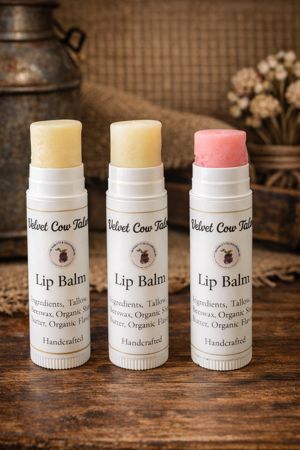 Three lip balm tubes with light beige and pink balm tops
