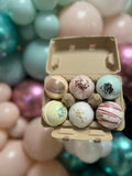 Mini bath bomb bundle in open kraft tray with assorted pastel bath bombs
