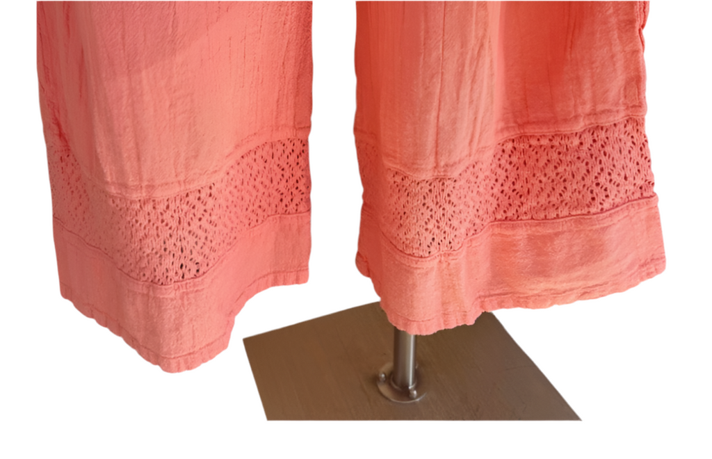 Peach pink cotton gauze pants close-up showing lace panel at hem