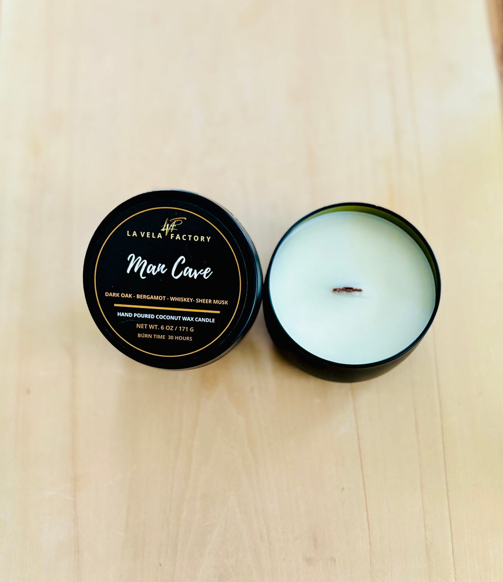 Cream wax wood wick candle labeled Man Cave in round tin