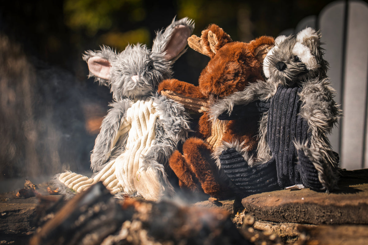 Frayed plush rope dog toy in tan, gray, and dark colors