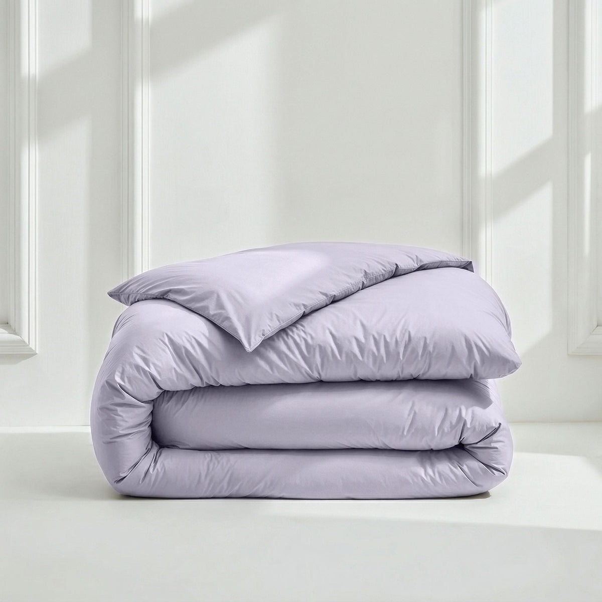 Lilac sateen bedding comforter bundle with a rolled duvet and matching pillow.