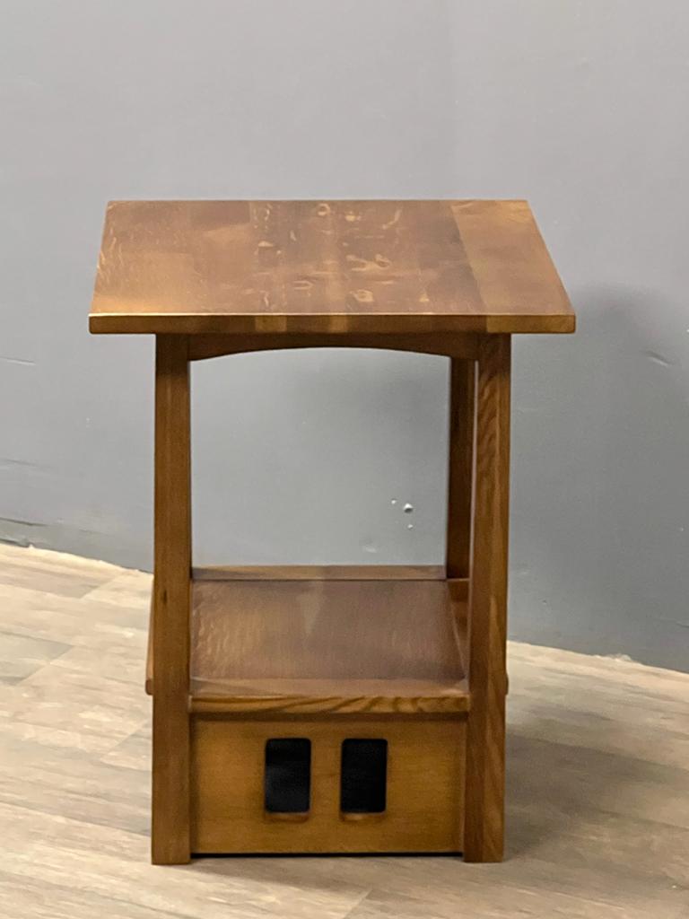 Wood taboret end table with open shelf and two square cutouts on front panel