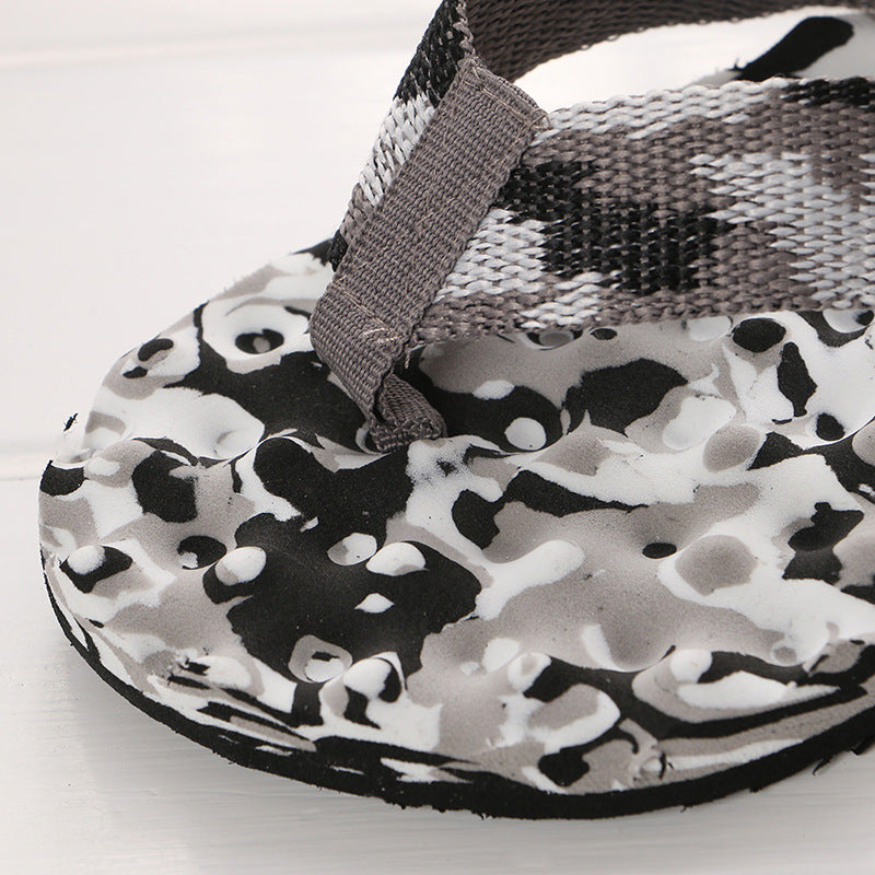 Close-up of black-and-white camo thong flip-flop with woven top strap